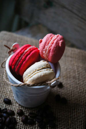 Colorful macaroons on old wooden backgroundの写真素材