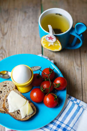 Healthy breakast with eggs, tea and tomatoes
