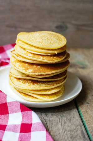 Sweets pancakes on the red napkin in the rustic style kitchen