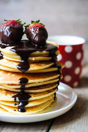 Sweets pancakes on the red napkin in the rustic style kitchenの写真素材