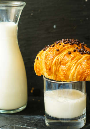 Breakfast time, fresh croissant with chocolate and milkの写真素材