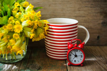 Tea time, red stripped cup of tea, spring flowers and Have a nice day note