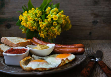 Lunch time with eggs and fried sausages