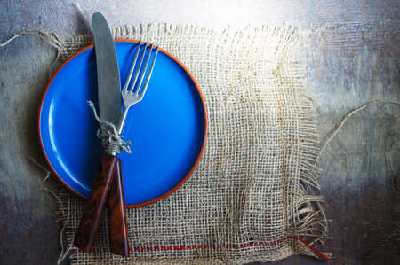 Table Setting with napkin and silverware on wooden tableの写真素材