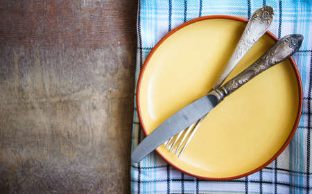 Table Setting with napkin and silverware on wooden tableの写真素材