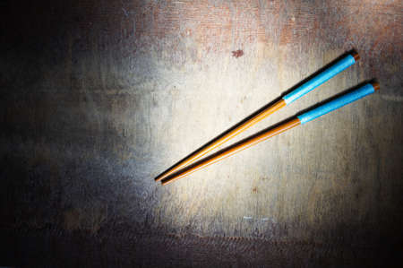 pair of chopsticks on rustic wooden backgroundの写真素材