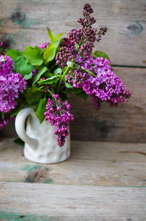Spring time, lowers o lilac in a pot in the rustic style interior