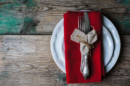 Table Setting with napkin and silverware on wooden tableの写真素材