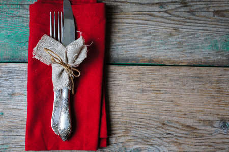 Table Setting with napkin and silverware on wooden tableの写真素材