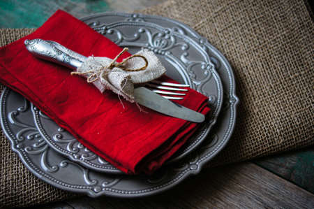 Table Setting with napkin and silverware on wooden tableの写真素材