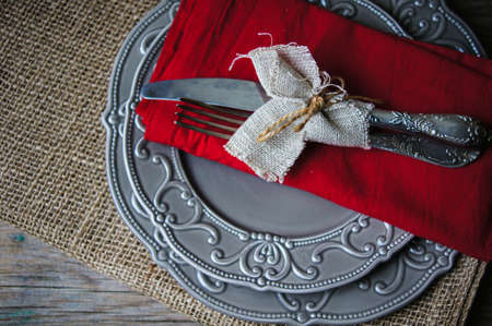 Table Setting with napkin and silverware on wooden tableの写真素材