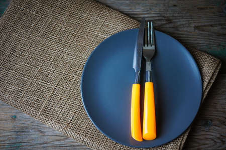 Table Setting with napkin and silverware on wooden tableの写真素材