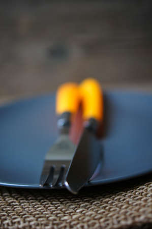 Table Setting with napkin and silverware on wooden tableの写真素材