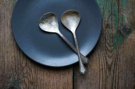 Vintage silverware on the old wooden tableの写真素材