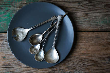 Vintage silverware on the old wooden tableの写真素材
