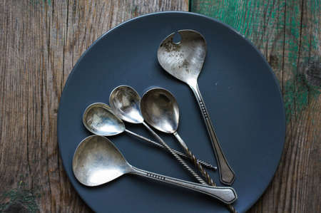 Vintage silverware on the old wooden tableの写真素材