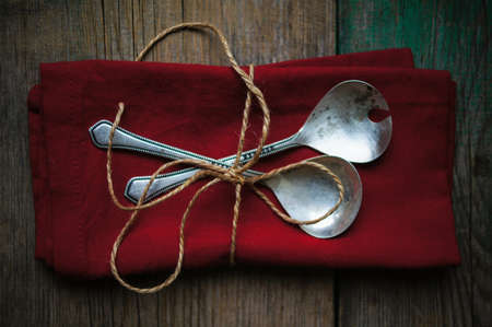 Vintage silverware on the old wooden tableの写真素材
