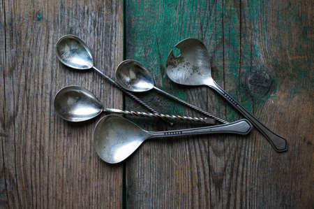Vintage silverware on the old wooden tableの写真素材