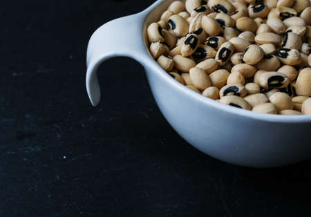 Dried black-eyed beans on the black stone backgroundの写真素材