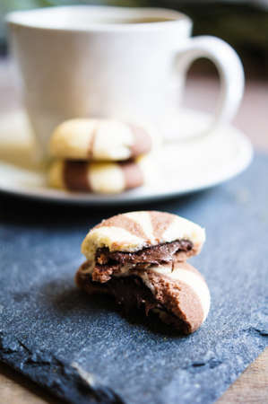 Cup of green tea and cookies on the tableの写真素材