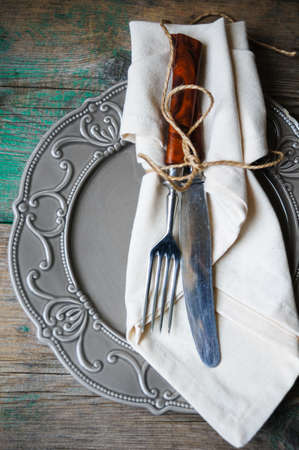 Table Setting with napkin and silverware on wooden tableの写真素材