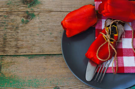 Red tulips with table set on a napkins, rusticの写真素材