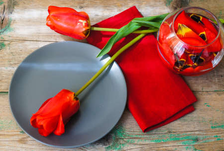 Red tulips with table set on a napkins, rusticの写真素材