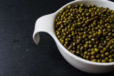 Green bean or mung bean on the black stone backgroundの写真素材