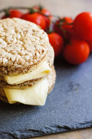 Healthy food, diet bread, cheese and cherry tomatoes on the rustic tableの写真素材