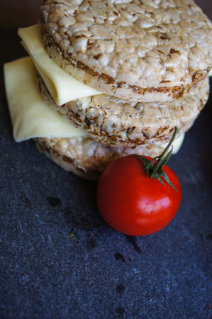 Healthy food, diet bread, cheese and cherry tomatoes on the rustic tableの写真素材