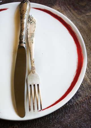 Plate and silverware on the old wooden table with burlap and napkinの写真素材