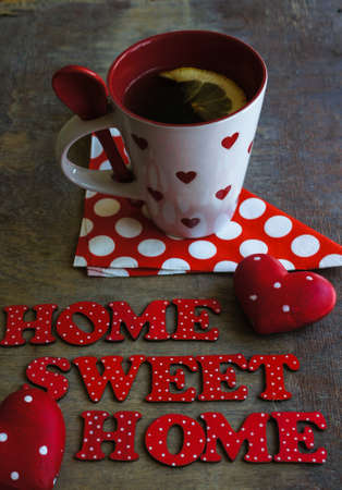 Red tea cup with tea and lemon on the old wooden background with noteの写真素材