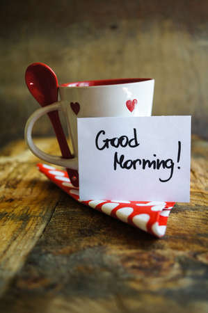 Red tea cup with tea and lemon on the old wooden background with noteの写真素材