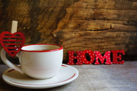 Cup of green tea and Home word on the old wooden backgroundの写真素材