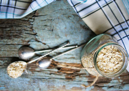 Oat flake in a bowl on rustic woodの写真素材