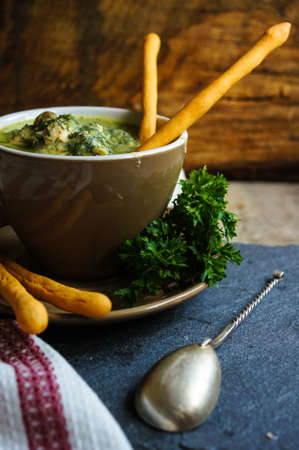 Chicken soup with bread sticks on the rustic kitchenの写真素材