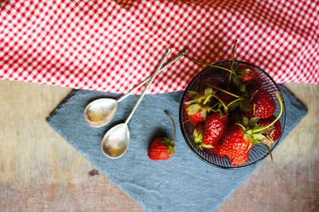 Fresh strawberries on the old wooden backgroundの写真素材