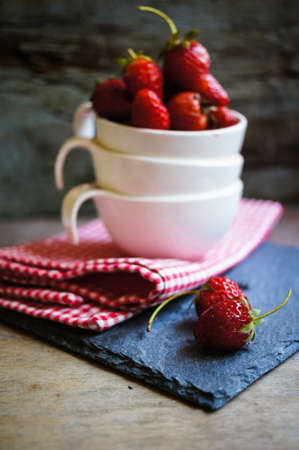 Fresh strawberries on the old wooden backgroundの写真素材