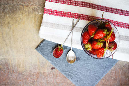Fresh strawberries on the old wooden backgroundの写真素材