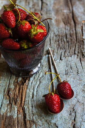 Fresh strawberries on the old wooden backgroundの写真素材