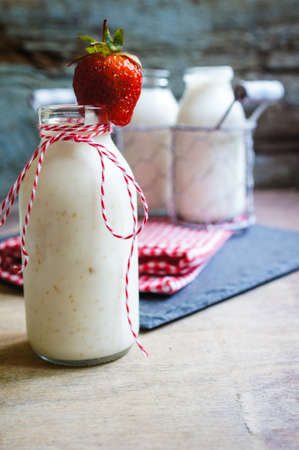 Strawberries yogurt and fresh fruits on the rustic kitchenの写真素材