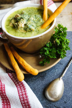 Chicken soup with bread sticks on the rustic kitchenの写真素材
