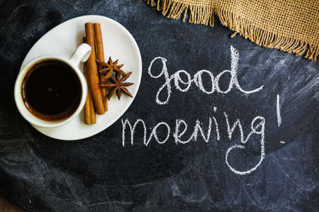 Coffee time, cup of black coffee and cinnamon and anise spices, Good morning noteの写真素材