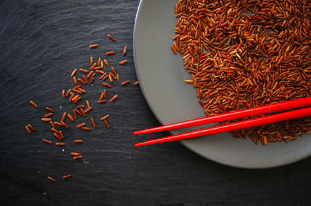 wild rice in ceramic bowl and chopsticks on wooden backgroundの写真素材