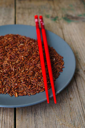 wild rice in ceramic bowl and chopsticks on wooden backgroundの写真素材