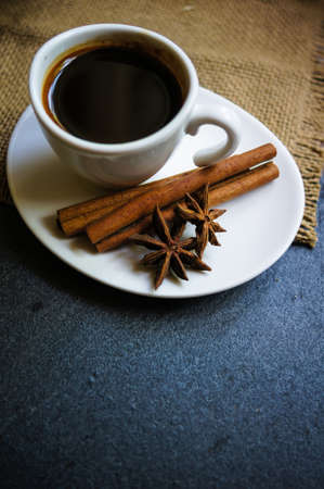 Coffee time, cup of black coffee and cinnamon and anise spices, Good morning noteの写真素材