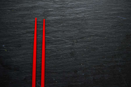 Red chopsticks on the rustic tableの写真素材
