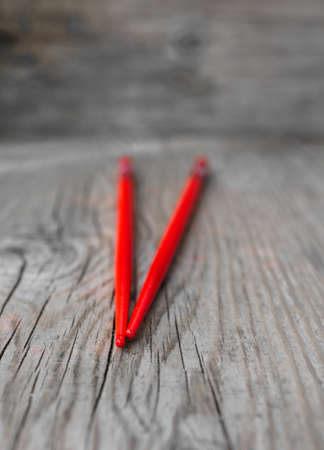 Red chopsticks on the rustic tableの写真素材