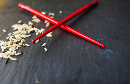 wild rice in ceramic bowl and chopsticks on wooden backgroundの写真素材