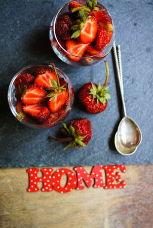 Fresh strawberries in the glasses as a dessert on rustic style tableの写真素材